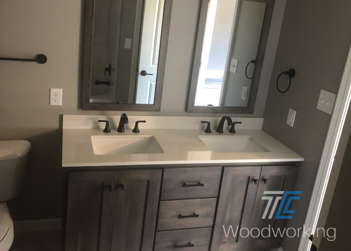 Dark brown bathroom vanity, dual sinks, white countertop, double mirrors