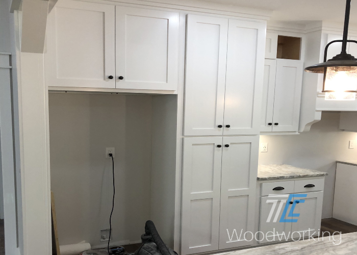 white kitchen cabinetry, black cabinet hardware, small granite counter