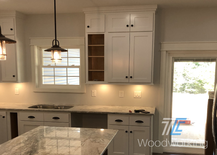 white cabinets, kitchen sink, over sink window, large window, grey marbled countertops